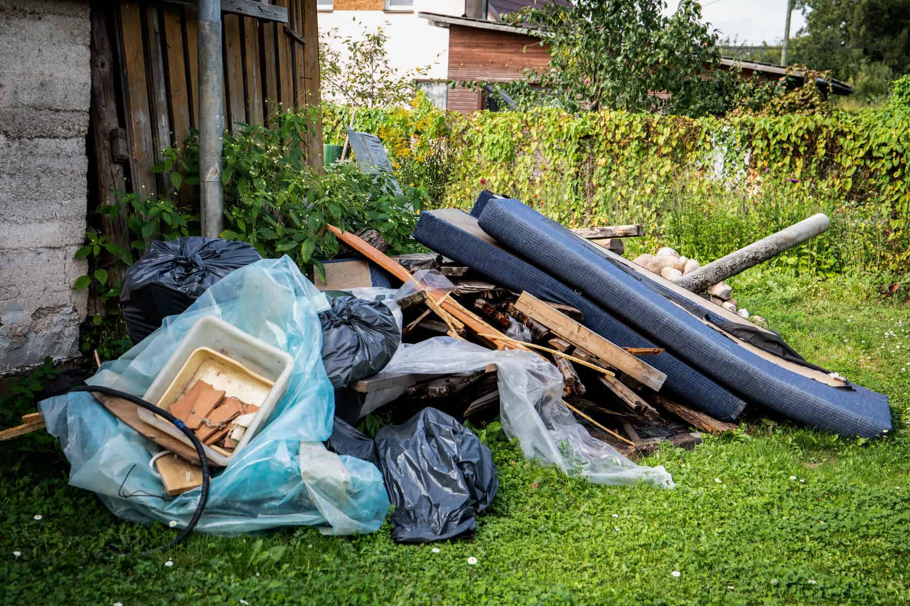 glen waverley - Garbage and a pile of construction debris in the yard of a house